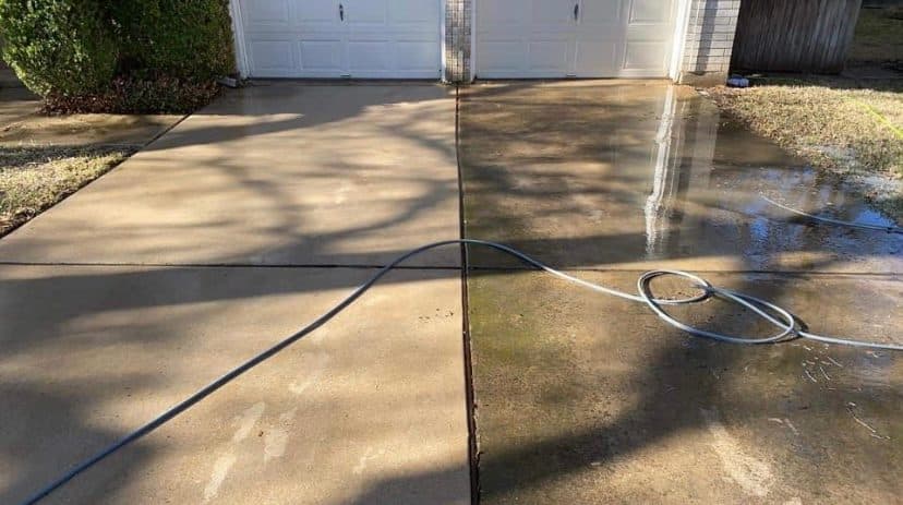 Driveway pressure washing in progress with clear dividing line between clean and dirty sections